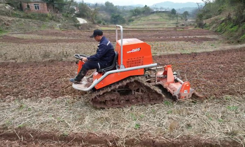 G25 rotary tiller attachment performing soil crushing in paddy field with 195mm blade radius.
